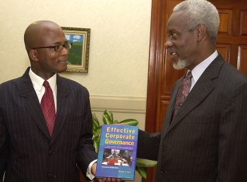 Junior Dowie / Staff Photographer
Author Vindel L. Kerr (left) presents a copy of his book, "Effective Corporate Governance", to Prime Minister P.J. Patterson at Jamaica House on March 29, 2005. The official launch will take place on April 4 at the Knutsford Court Hotel, during a public forum under the theme "Examining the qualities of the next Prime Minister ... Improving Corporate and Political Governance in Jamaica."